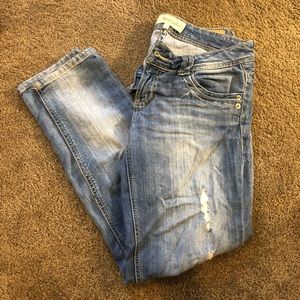 Light wash lightly distressed jeans.